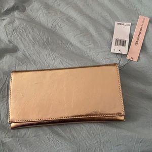 Brand new rose gold clutch. Mint condition and never used. Chain inside.
